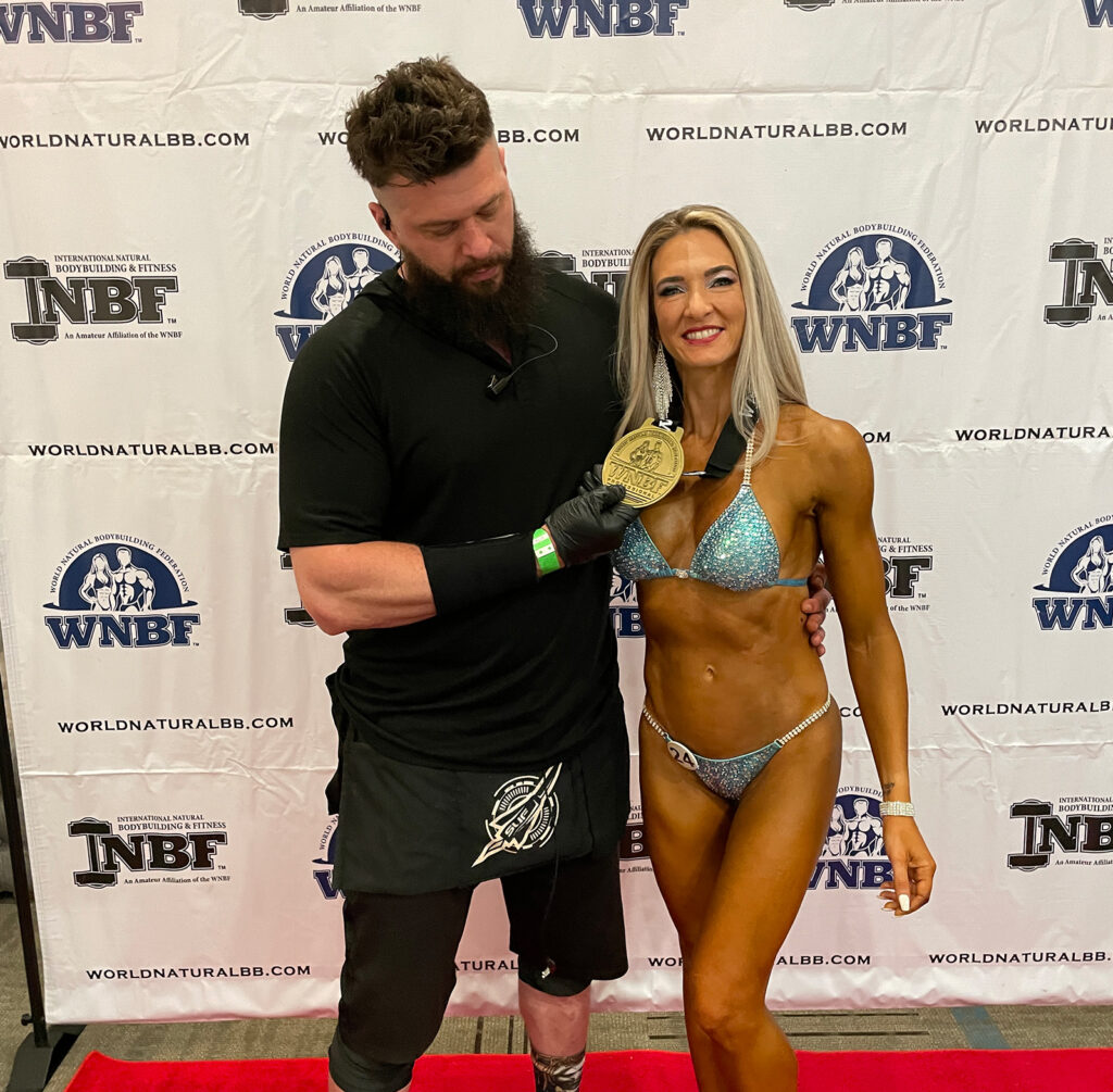 natural bodybuilding coach Ryan Sullivan of Team SUF celebrates with Jessica Hiatt After she won the Pro Bikini Class at the 2021 WNBF Pro Universe