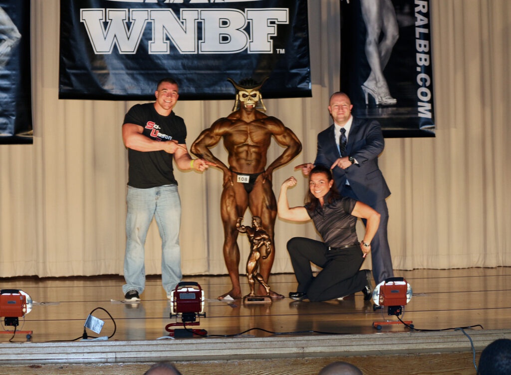 Nancy Andrews poses with Team SUF Bodybuilding Champions at the 2015 INBF Hercules
